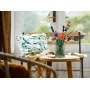 Bouquet LEGO coloré dans un vase vert sur une table en bois près d'une fenêtre avec coussin fleuri Bouquet LEGO coloré dans un vase vert sur une table en bois près d'une fenêtre avec coussin fleuri