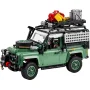 Land Rover Defender 90 LEGO vert avec galerie de toit chargée d'équipements et bagages colorés, vue de trois-quarts avant
