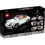 Boîte LEGO montrant une Porsche 911 blanche construite en briques, avec détails oranges et multiples vues du modèle sur fond noir