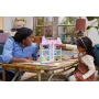 Mother and daughter playing with pink cat-shaped LEGO dollhouse with multiple rooms on wooden table Mother and daughter playing with pink cat-shaped LEGO dollhouse with multiple rooms on wooden table
