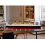 LEGO Titanic model with red hull and white superstructure, 4 yellow funnels, displayed on wooden table in elegant living room LEGO Titanic model with red hull and white superstructure, 4 yellow funnels, displayed on wooden table in elegant living room