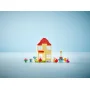 LEGO Peppa Pig house with red roof surrounded by colorful party accessories, birthday cake and characters LEGO Peppa Pig house with red roof surrounded by colorful party accessories, birthday cake and characters