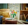 LEGO colorful flower bouquet in clear glass vase on round wooden table, cozy living room setting in background LEGO colorful flower bouquet in clear glass vase on round wooden table, cozy living room setting in background