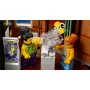 Indoor scene with LEGO minifigures: curly-haired man reading newspaper next to red-haired woman with glasses Indoor scene with LEGO minifigures: curly-haired man reading newspaper next to red-haired woman with glasses