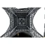 Upward view of the intricate metal framework of the LEGO Eiffel Tower, showing detailed beams and arches