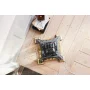 Complete view of built LEGO Eiffel Tower, grey metallic structure with golden base on wooden floor