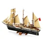 LEGO Endurance ship with black hull, tan sails unfurled, three masts and red flag displayed on wooden stand