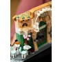 Detailed view of LEGO French café with green facade, orange awning, Café Fleur sign, terrace with white chairs and pink flowers