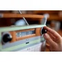 Hand turning the black volume knob of the orange and green LEGO retro radio with extended telescopic antenna Hand turning the black volume knob of the orange and green LEGO retro radio with extended telescopic antenna